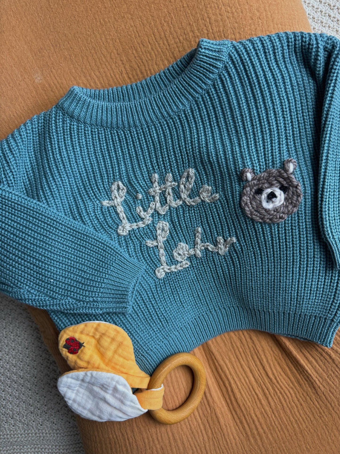 Personalisierter Kinderpullover mit handbesticktem Namen