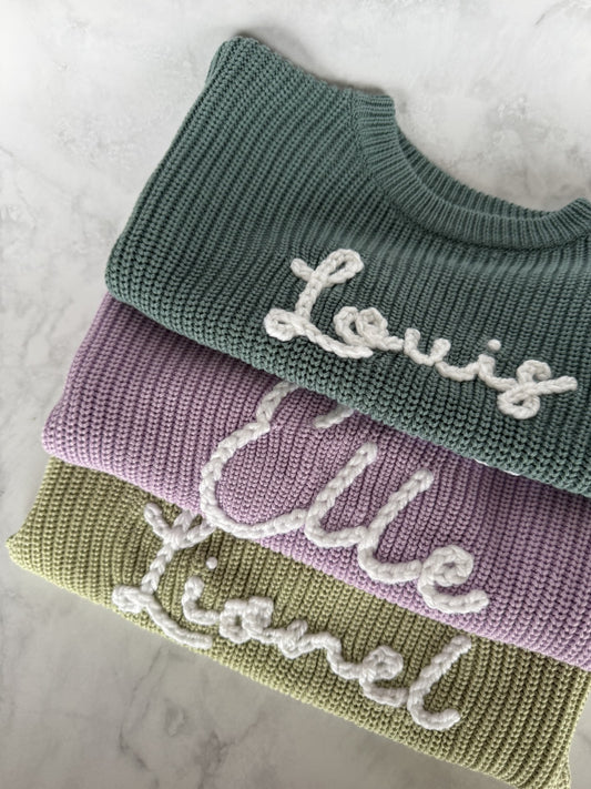 Personalisierter Kinderpullover mit handbesticktem Namen